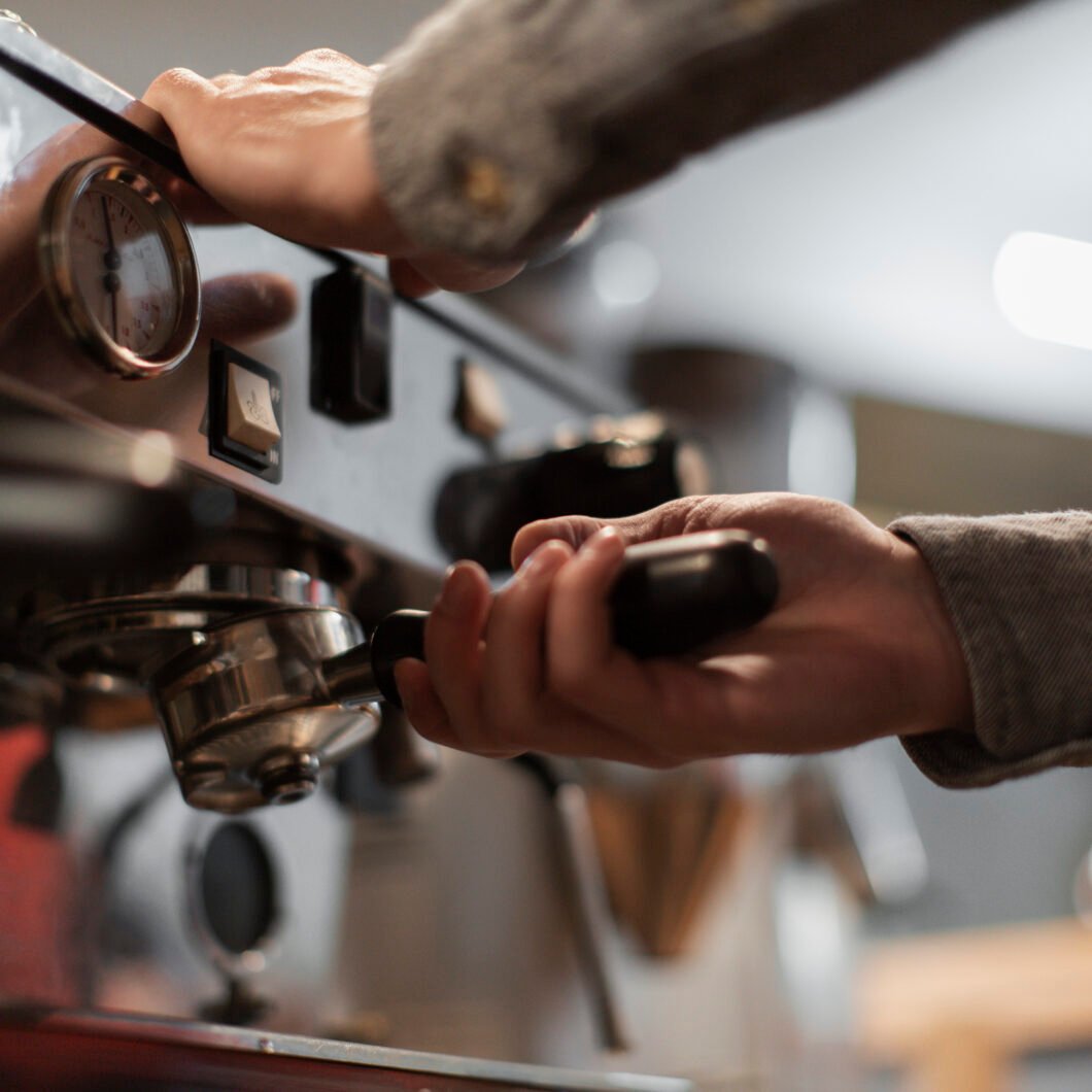 close-up-hands-working-coffee-machine